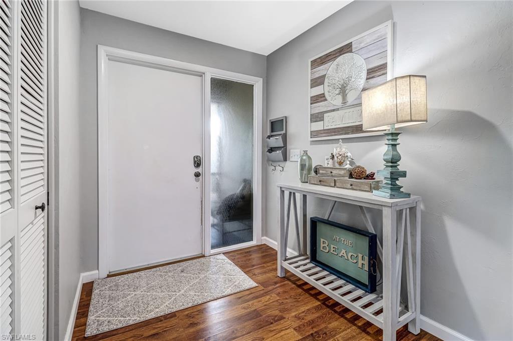 4576 Eagle Key Circle Naples, FL 34112 - Photo 4 of 18 a living room with furniture and a fireplace