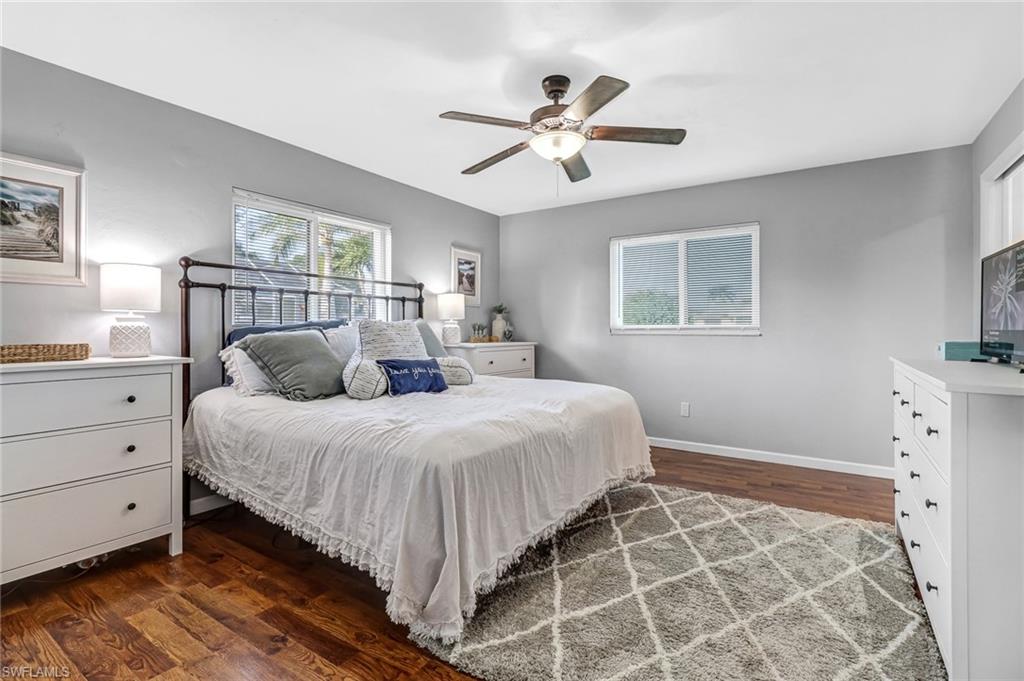 4576 Eagle Key Circle Naples, FL 34112 - Photo 6 of 18 a bedroom with a large bed and a chandelier