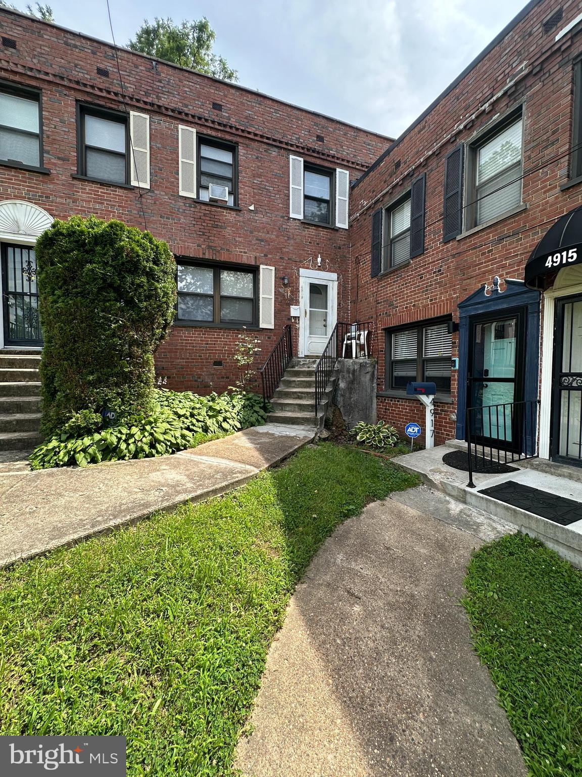 4919 Sheriff Road Northeast Washington, DC 20019 - Photo 2 of 4 front view of a brick house with a yard