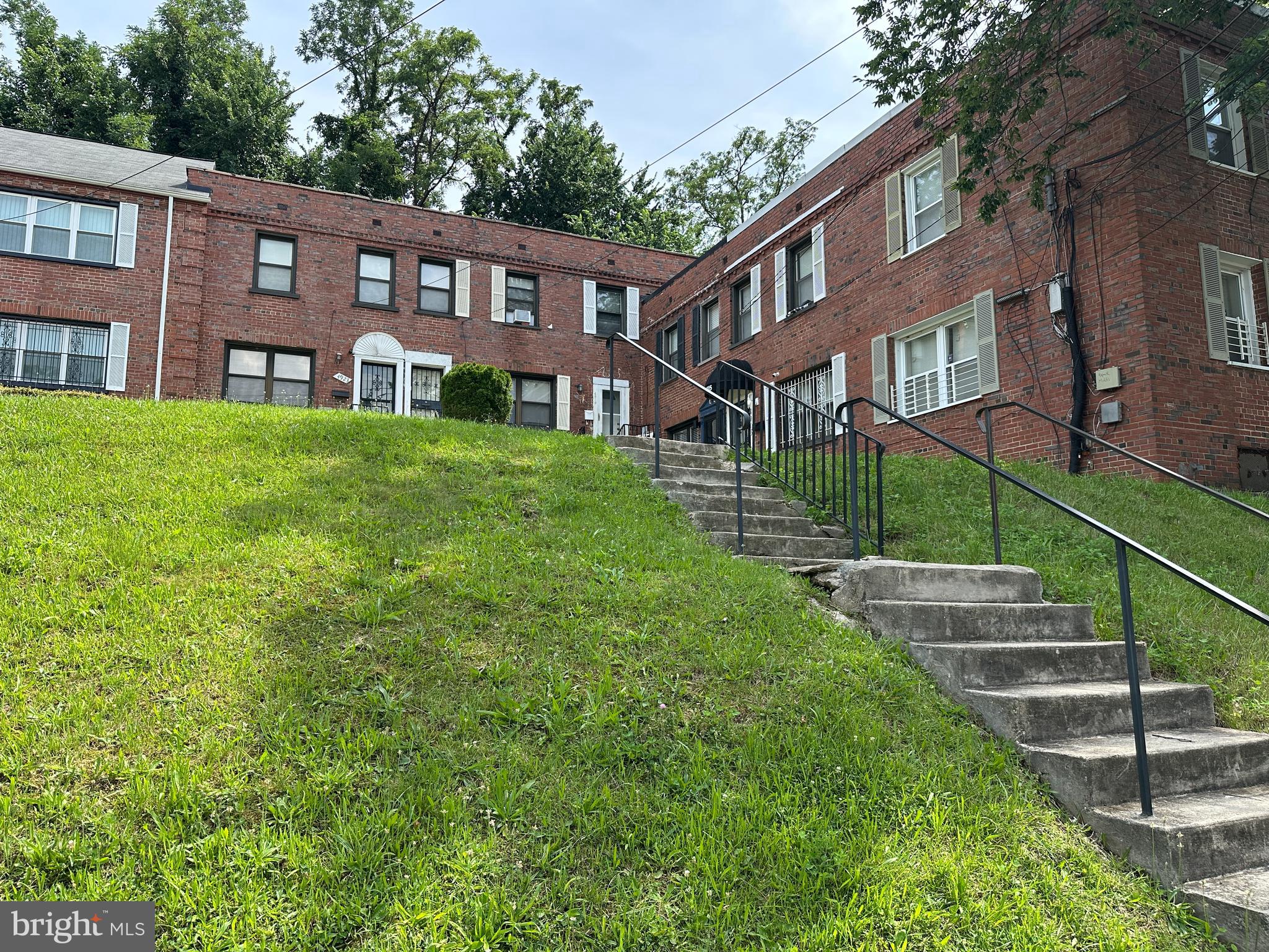 4919 Sheriff Road Northeast Washington, DC 20019 - Photo 3 of 4 a view of a brick building next to a big yard
