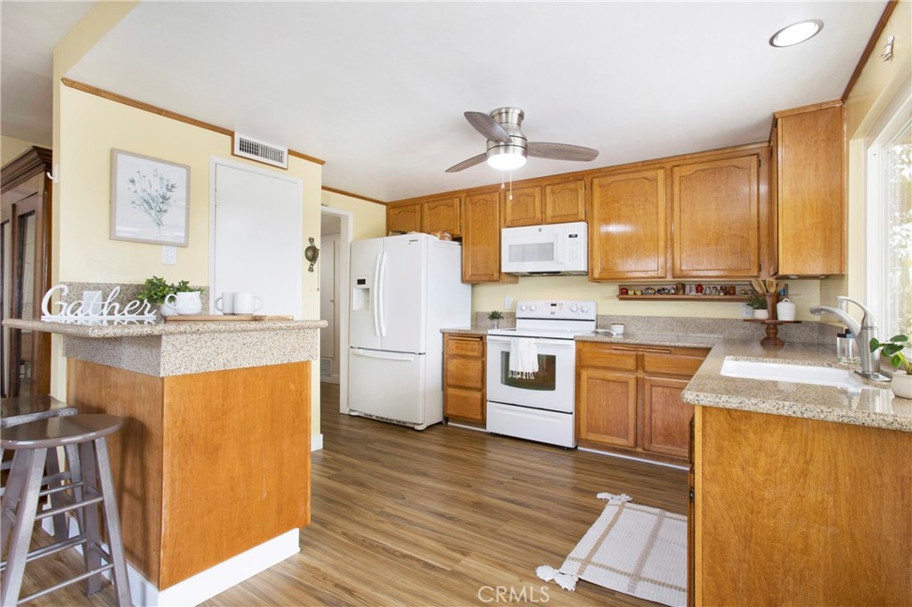 1936 Skywood Street Brea, CA 92821 - Photo 16 of 32 a kitchen with refrigerator cabinets and wooden floor
