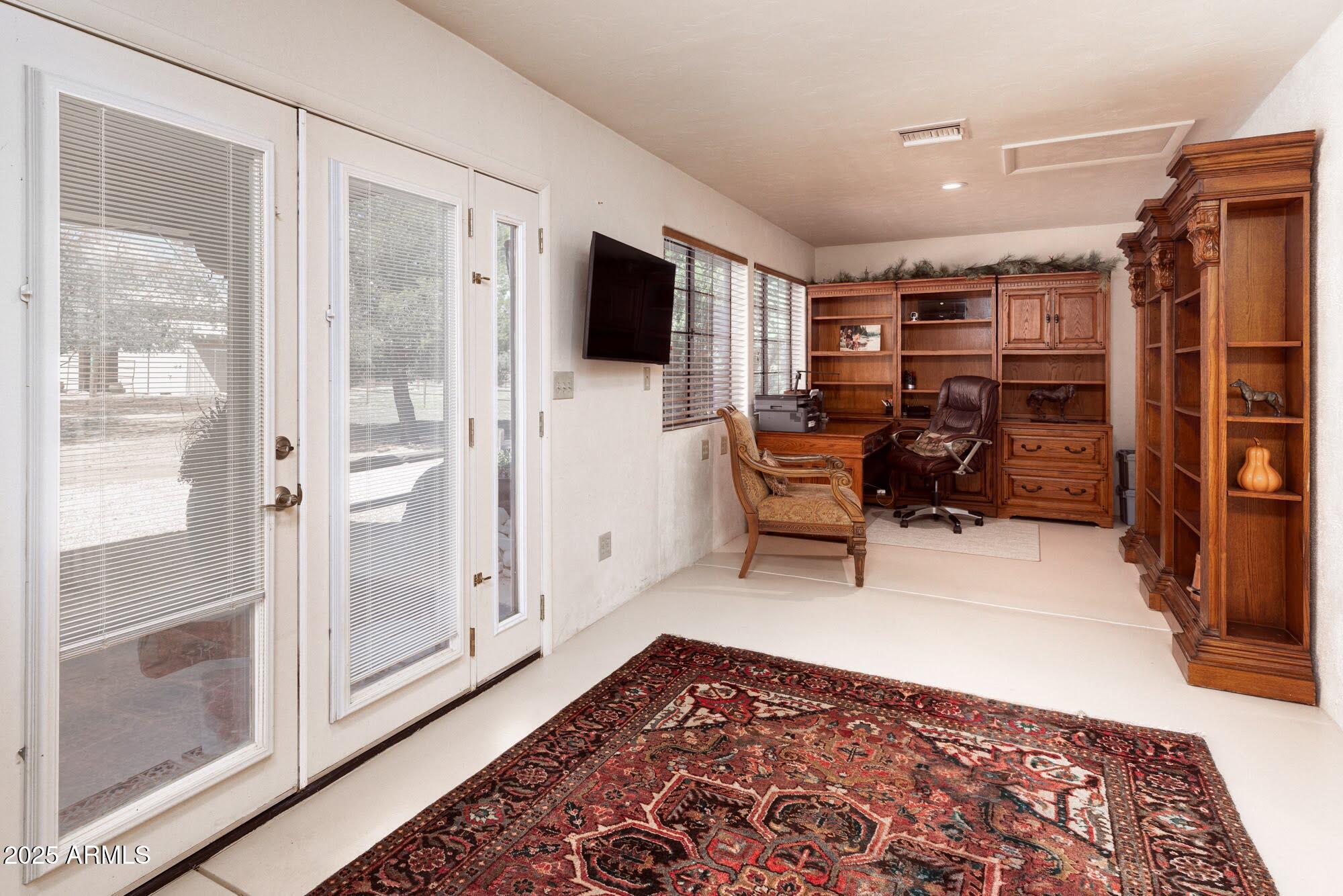 712 West Treasure Road Pearce, AZ 85625 - Photo 12 of 38 a living room with furniture and a flat screen tv