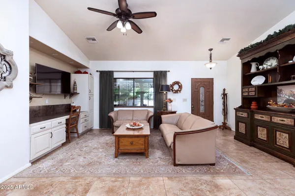 a living room with furniture and flat screen tv