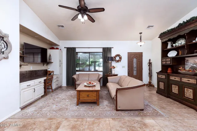 a living room with furniture and flat screen tv