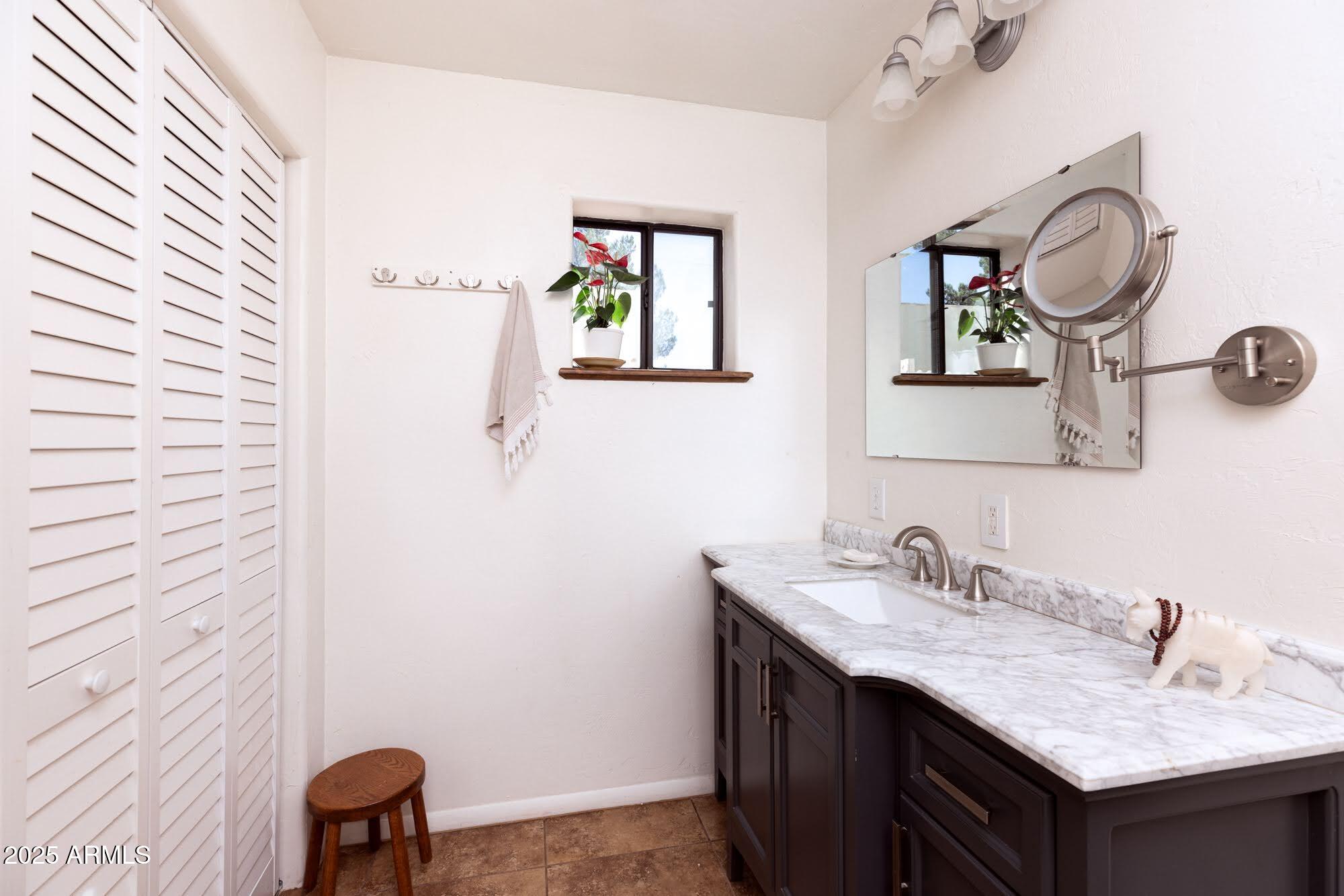 712 West Treasure Road Pearce, AZ 85625 - Photo 25 of 38 a bathroom with a sink and a mirror