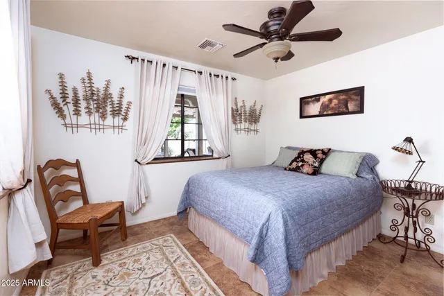 a bedroom with a bed and a chair