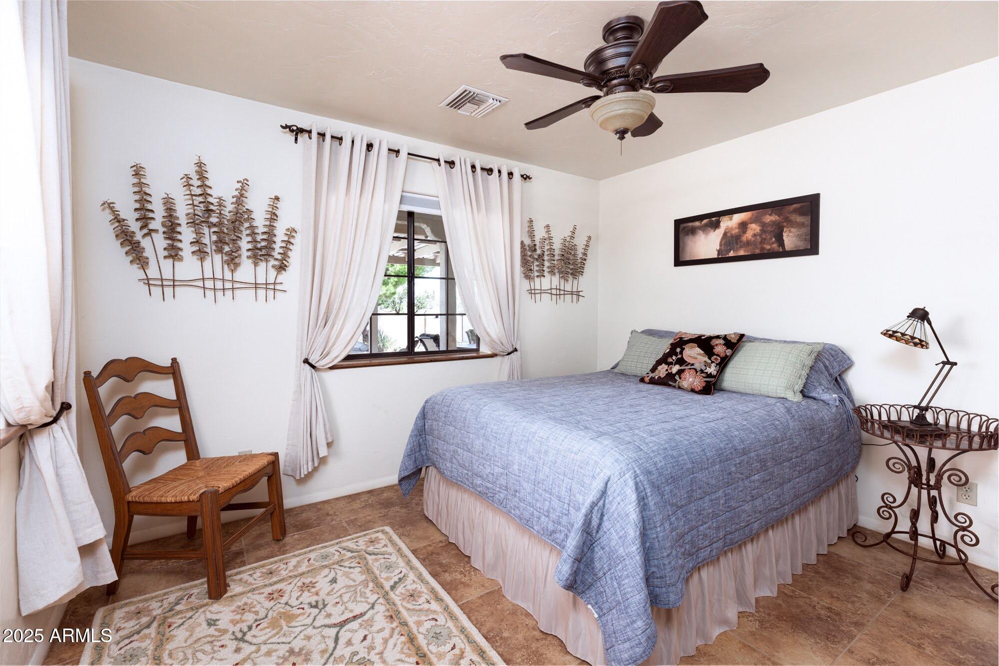 712 West Treasure Road Pearce, AZ 85625 - Photo 28 of 38 a bedroom with a bed and a chair