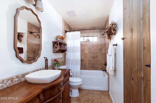 a bathroom with a toilet a sink and a mirror