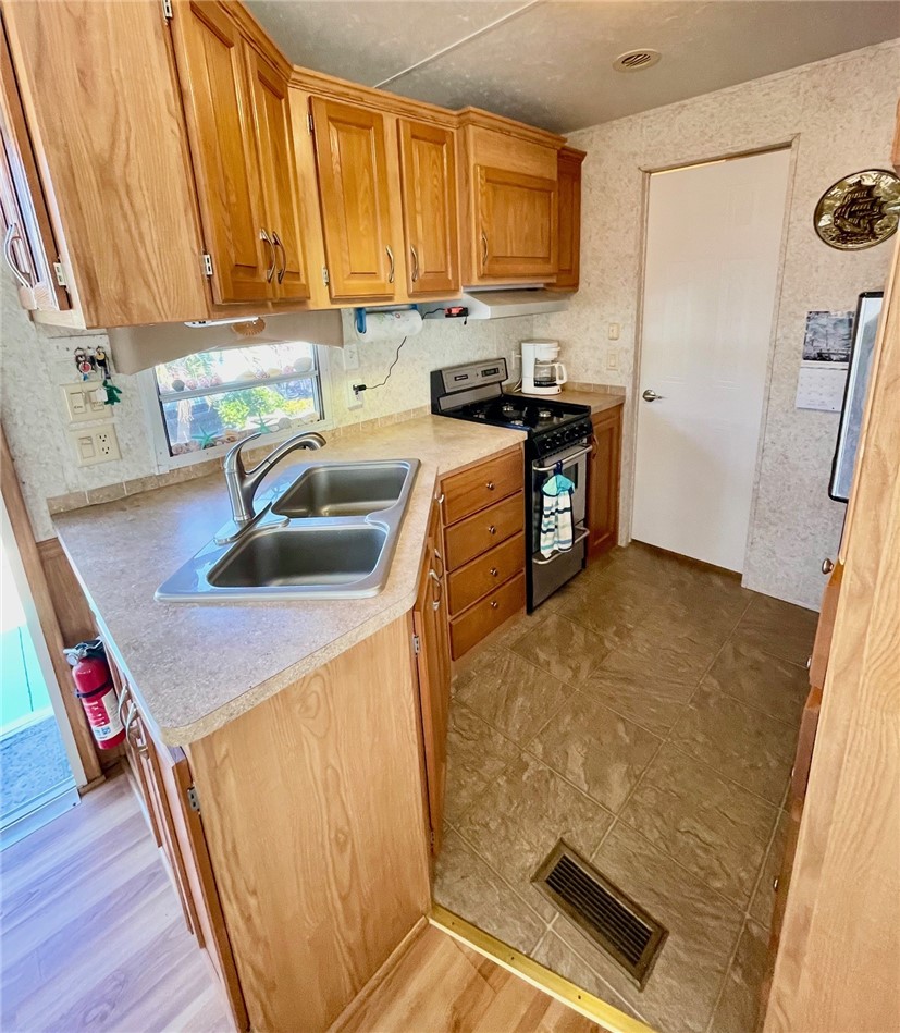 5288 Inlet Way Hutchinson Island, FL 34949 - Photo 14 of 21 a kitchen with a sink a stove and a refrigerator