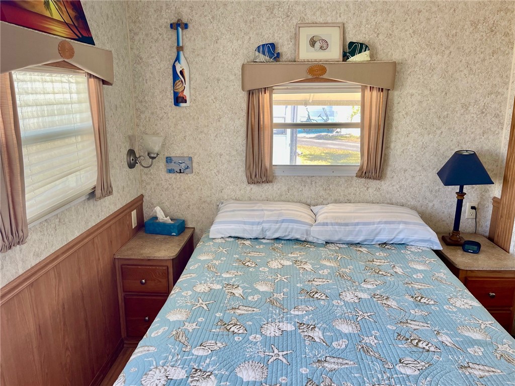 5288 Inlet Way Hutchinson Island, FL 34949 - Photo 18 of 21 a bedroom with a bed and a lamp next to a window