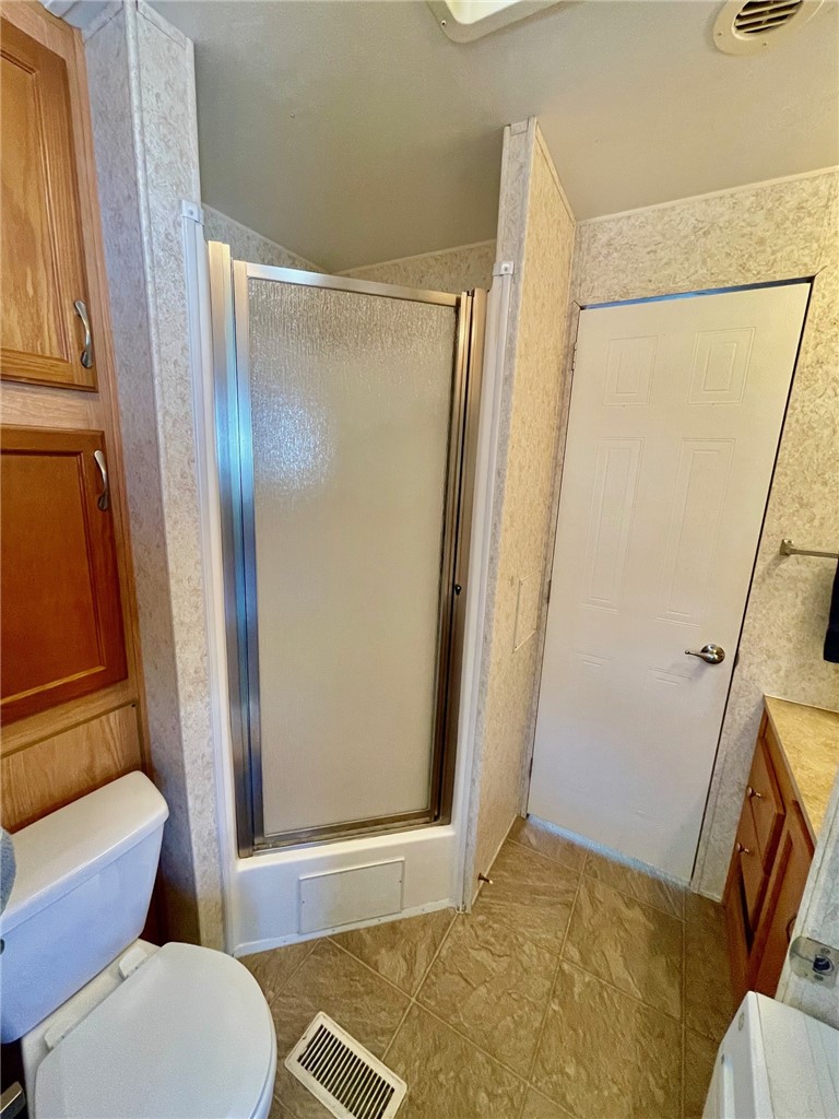 5288 Inlet Way Hutchinson Island, FL 34949 - Photo 20 of 21 a bathroom with a tub and a glass door