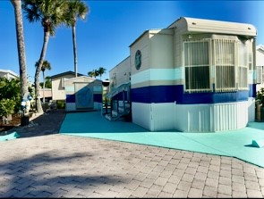 5288 Inlet Way Hutchinson Island, FL 34949 - Photo 2 of 21 a view of a house with a yard and potted plants