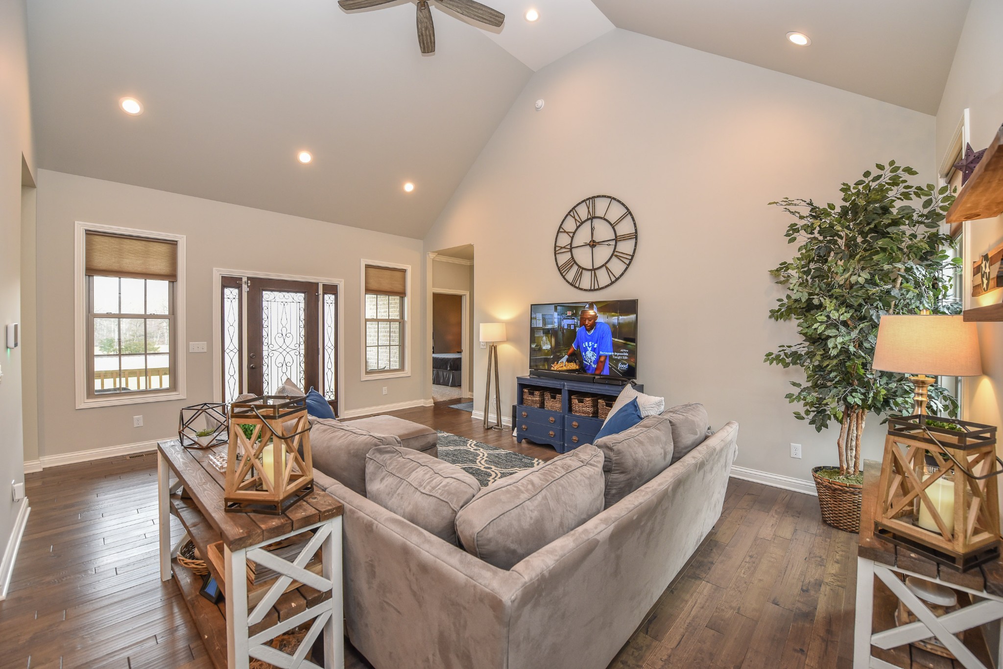 1648 Old Gallatin Road Portland, TN 37148 - Photo 12 of 25 a living room with furniture a dining table and a potted plant with wooden floor