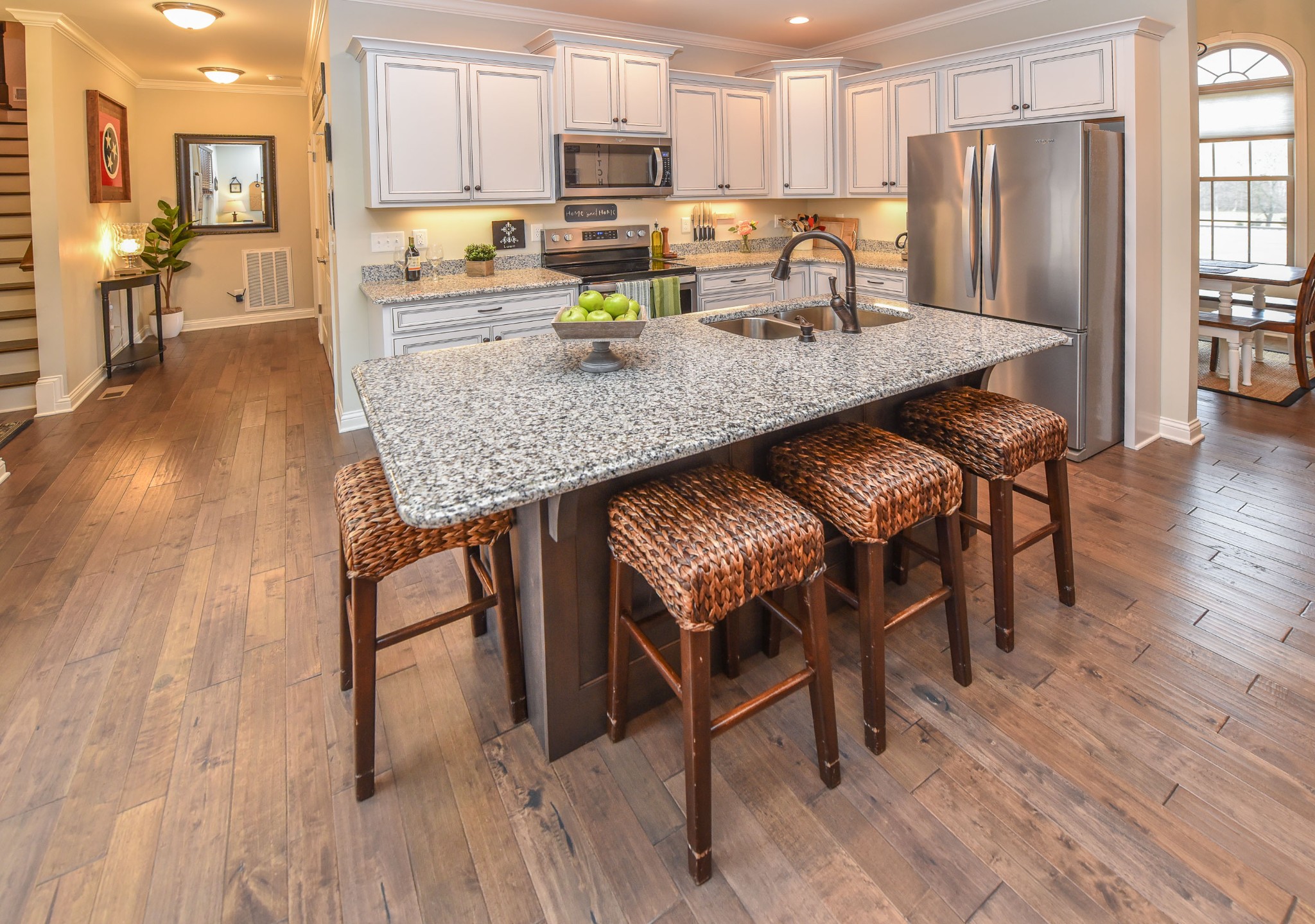 1648 Old Gallatin Road Portland, TN 37148 - Photo 9 of 25 a kitchen with stainless steel appliances granite countertop a stove a refrigerator a sink a dining table and chairs with wooden floor