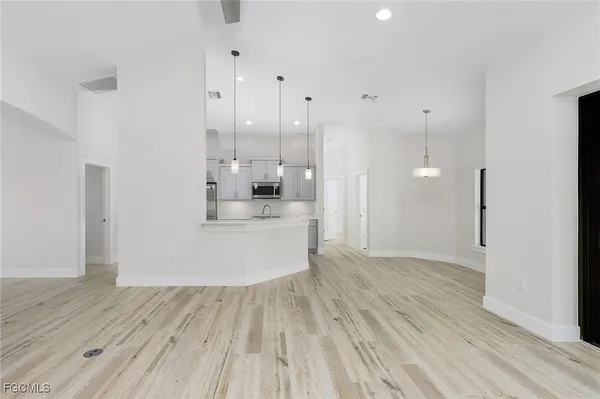 a view of a kitchen with wooden floor