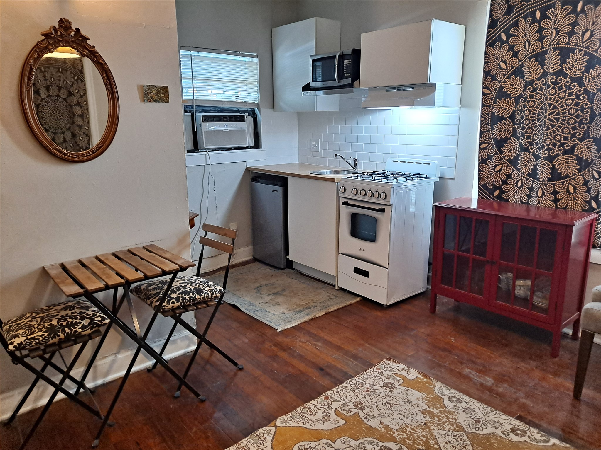 1906 San Gabriel Street, Unit 17 Austin, TX 78705 - Photo 5 of 7 a kitchen with a stove and a microwave