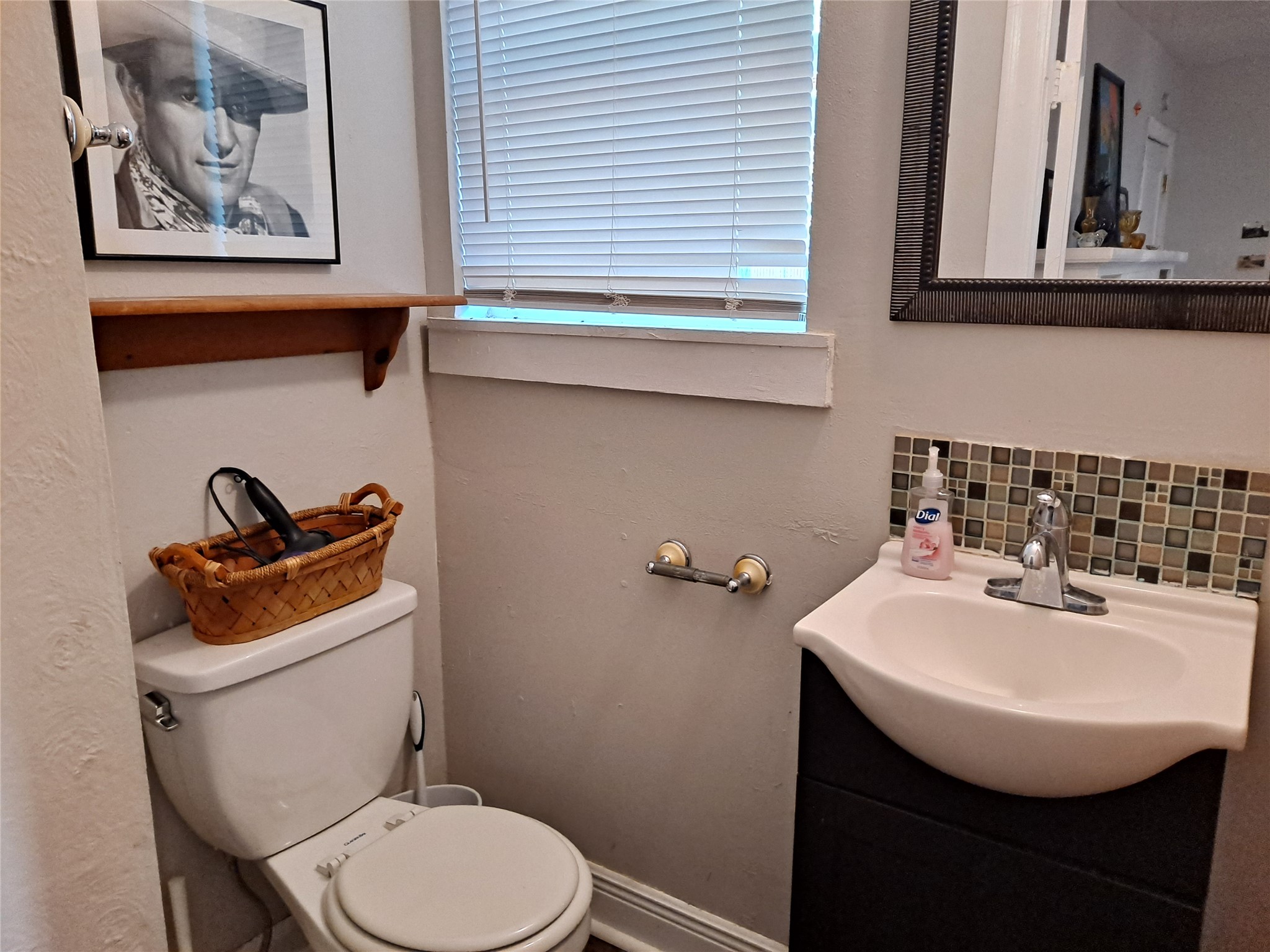 1906 San Gabriel Street, Unit 17 Austin, TX 78705 - Photo 6 of 7 a bathroom with a sink a toilet and a mirror