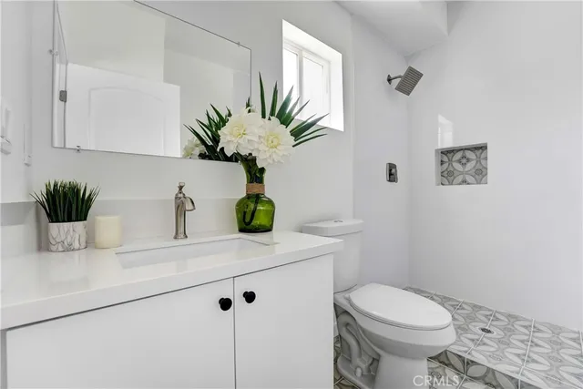 a bathroom with a sink a toilet and a mirror