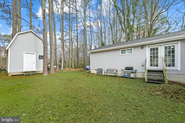 a backyard of a house with table and chairs