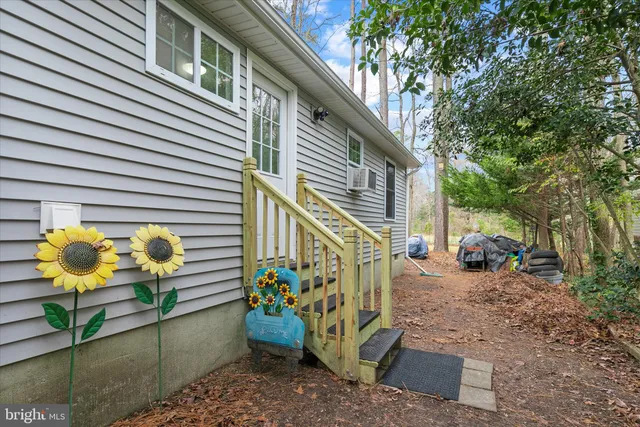 a view of a house with sitting area and potted plants