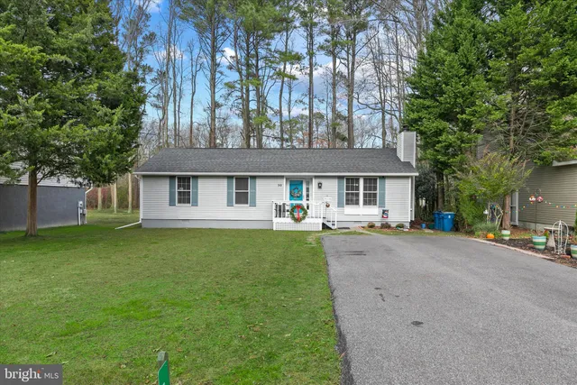 a front view of a house with a garden and porch