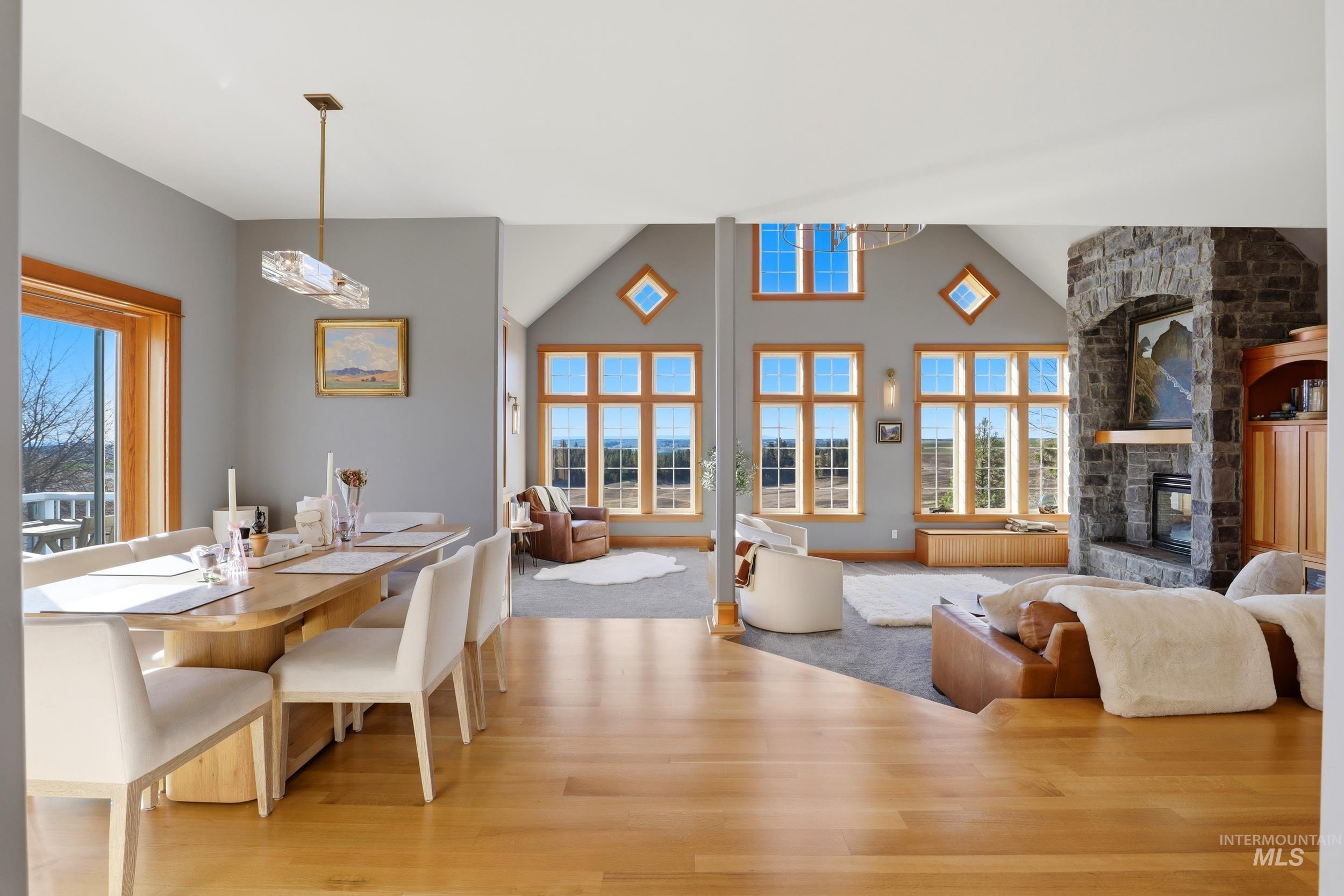 1014 Hilby Road Moscow, ID 83843 - Photo 13 of 50 Dining space featuring plenty of natural light, light wood-style flooring, lofted ceiling, and a stone fireplace