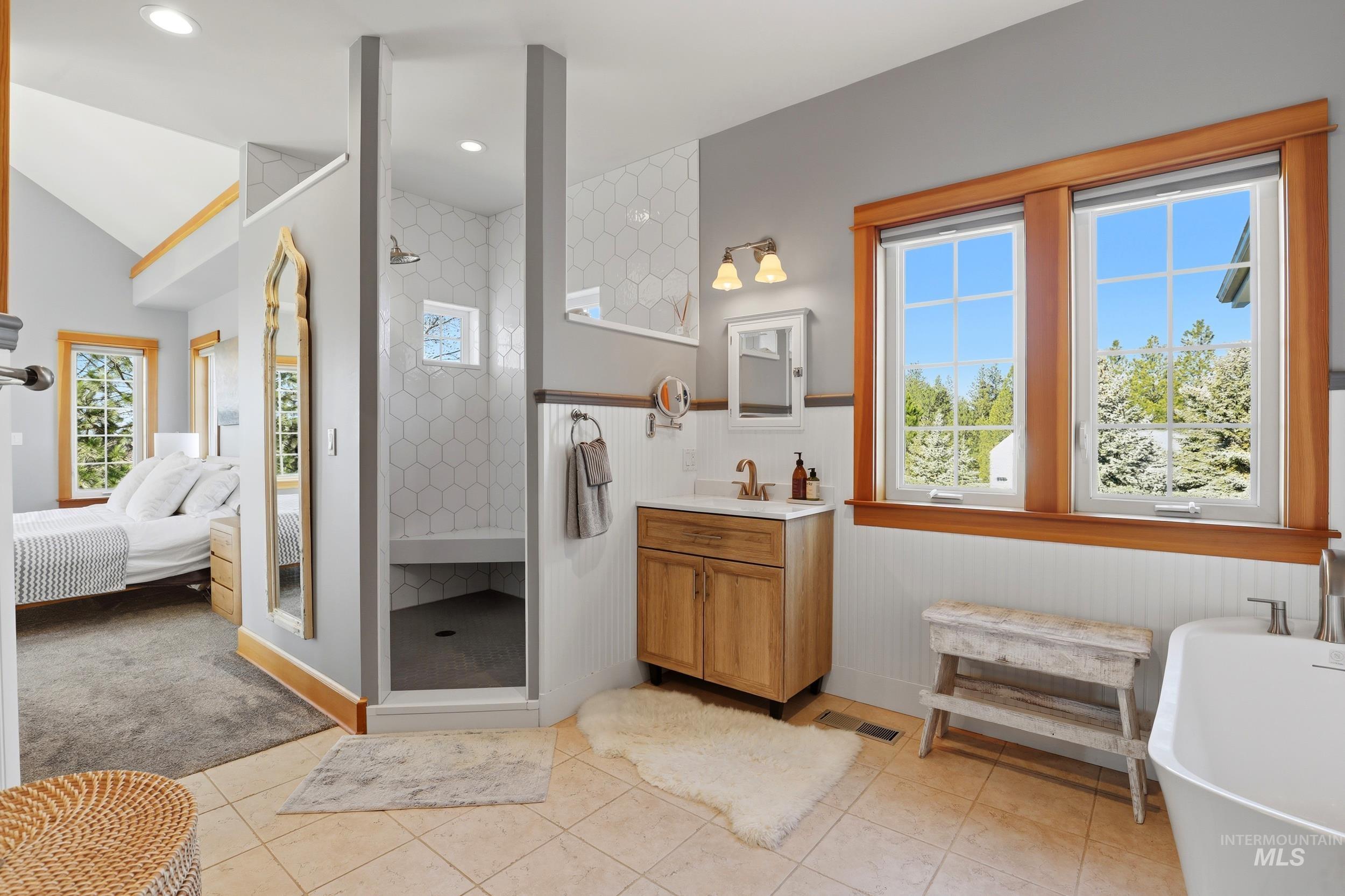 1014 Hilby Road Moscow, ID 83843 - Photo 20 of 50 Bathroom with walk in shower, vanity, a freestanding tub, ensuite bathroom, and light tile patterned floors