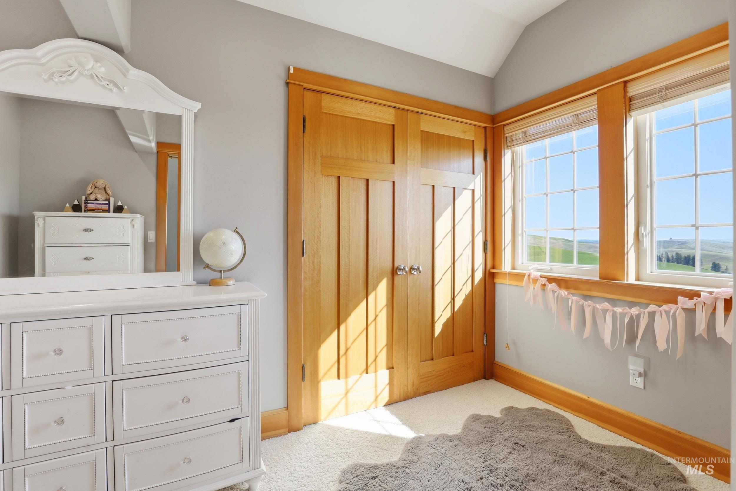 1014 Hilby Road Moscow, ID 83843 - Photo 27 of 50 Bedroom featuring light colored carpet, vaulted ceiling, and a closet