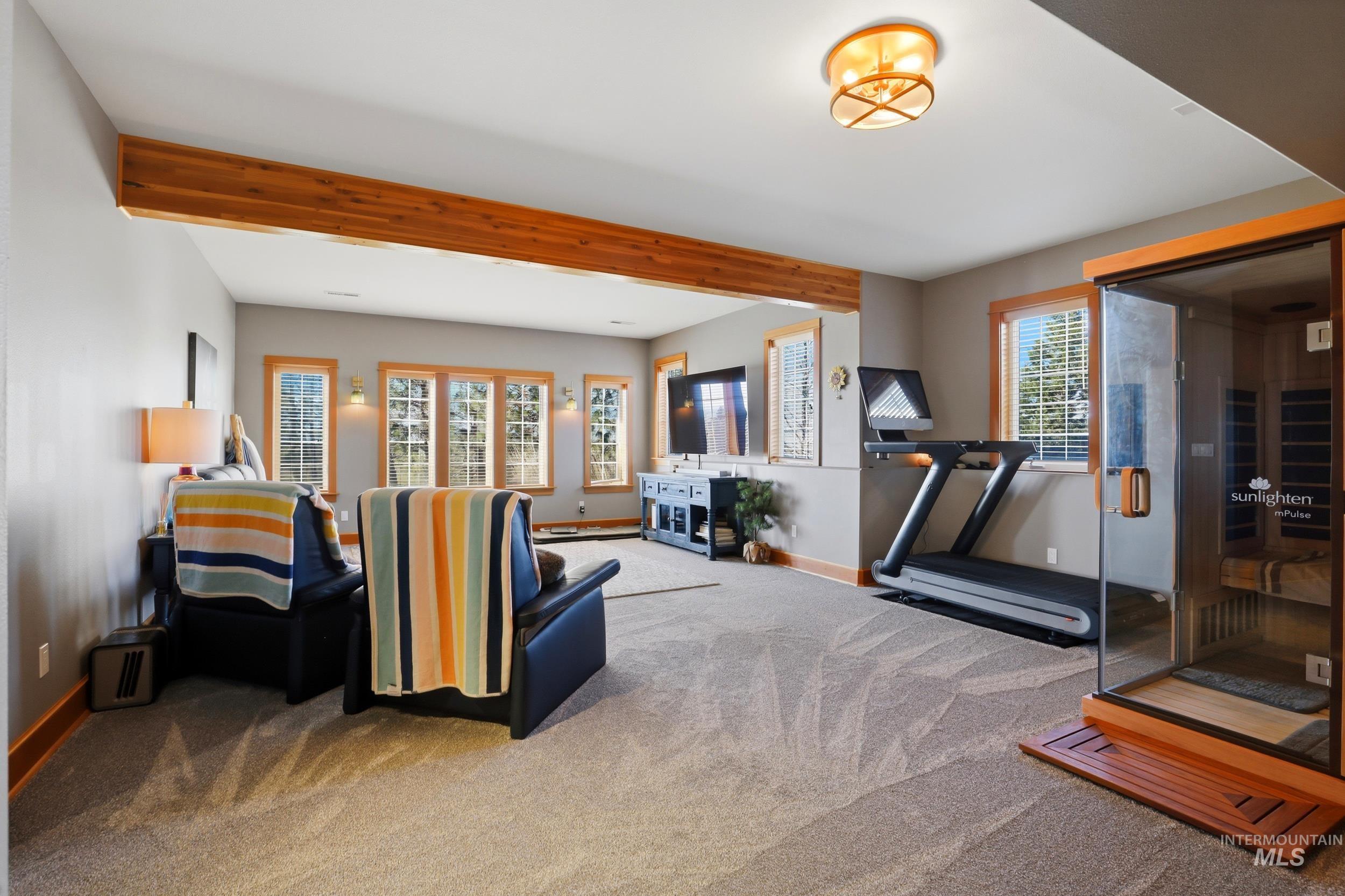 1014 Hilby Road Moscow, ID 83843 - Photo 31 of 50 Carpeted living room featuring a sauna / steam room and beam ceiling