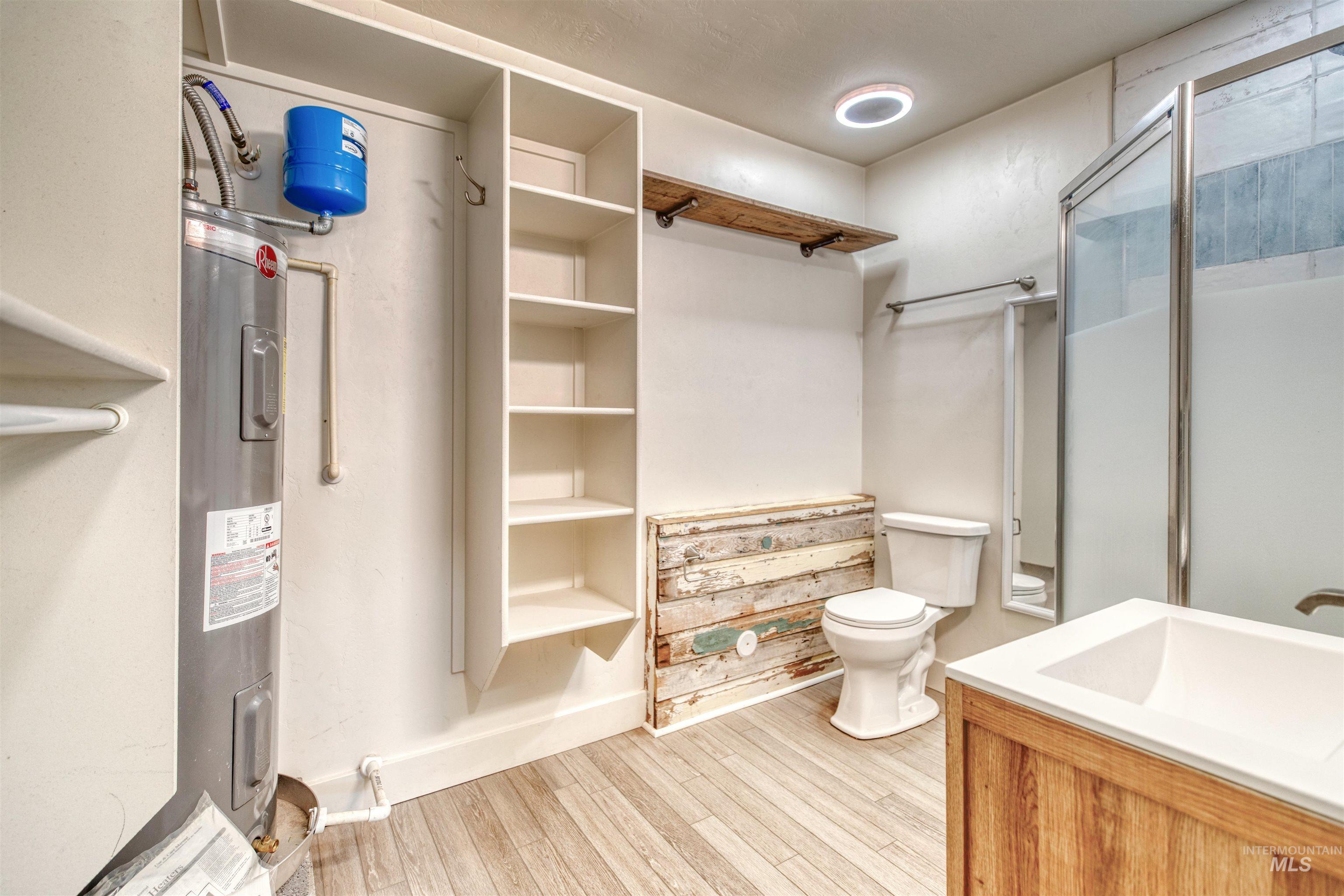 108 East Main Street Nyssa, OR 97913 - Photo 4 of 19 Bathroom featuring wood finished floors, a shower stall, and vanity