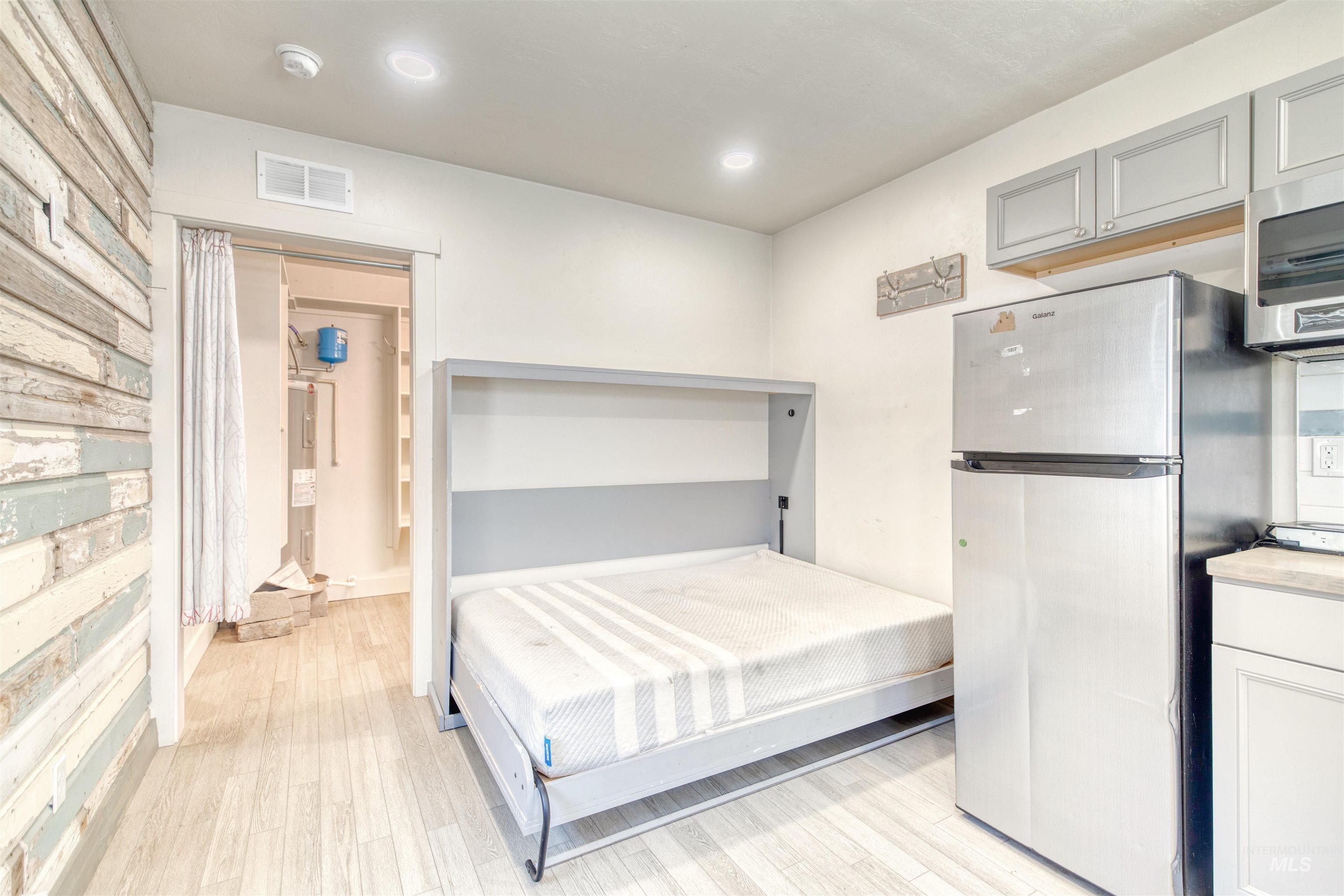 108 East Main Street Nyssa, OR 97913 - Photo 7 of 19 Bedroom featuring freestanding refrigerator, light wood-style flooring, and recessed lighting
