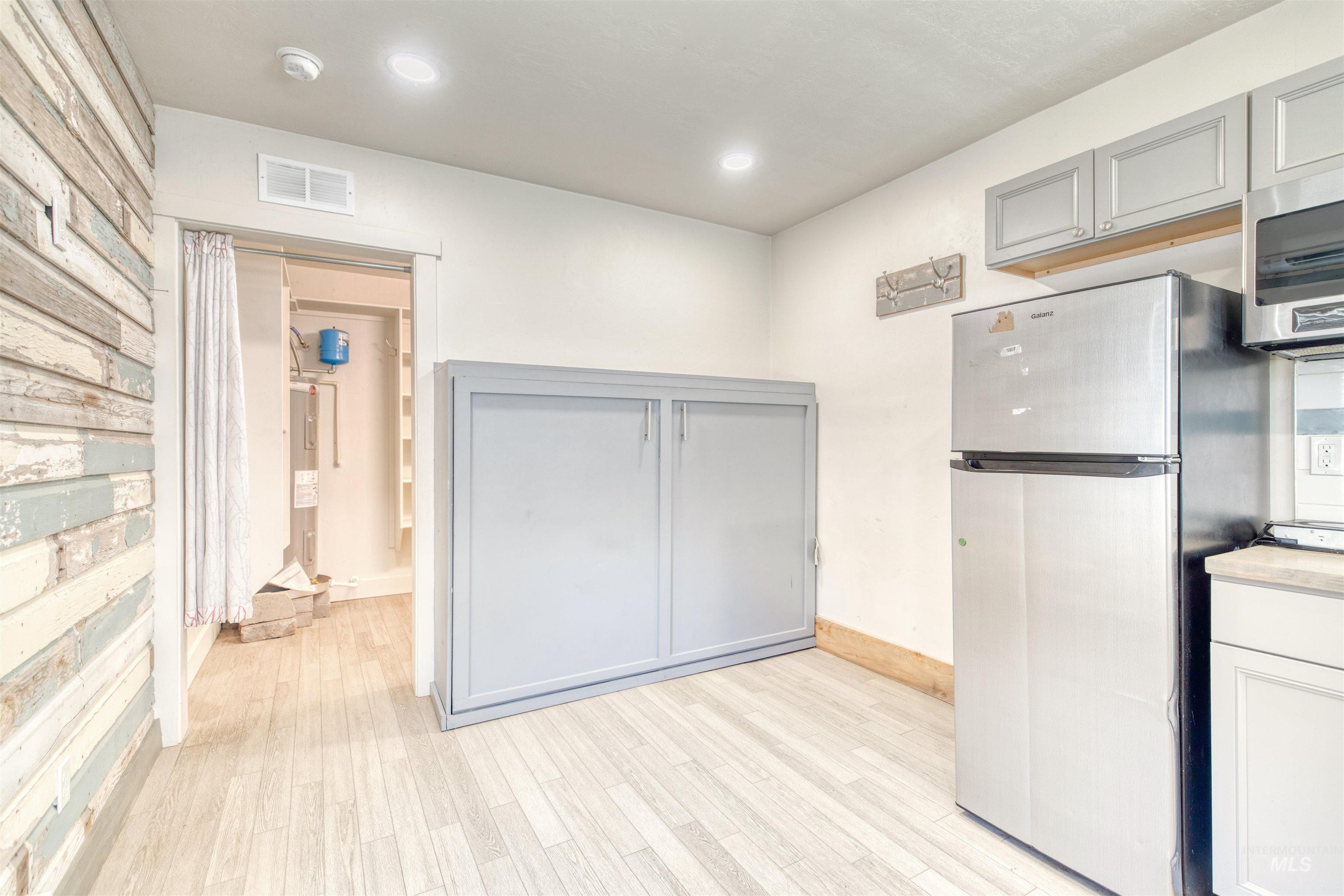 108 East Main Street Nyssa, OR 97913 - Photo 8 of 19 Kitchen with appliances with stainless steel finishes, gray cabinetry, light wood-style floors, light countertops, and recessed lighting
