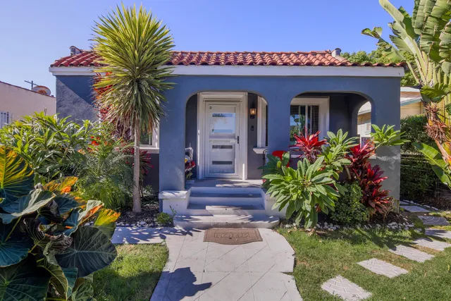 front view of a house with a potted plant