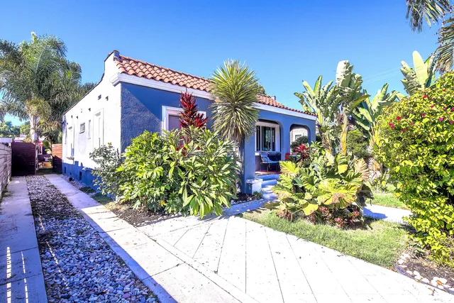 a view of a house with potted plants