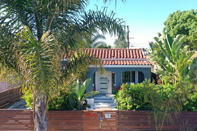 a view of a house with a tree