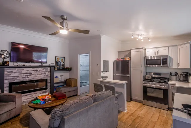 a kitchen with stainless steel appliances kitchen island granite countertop a stove and a refrigerator