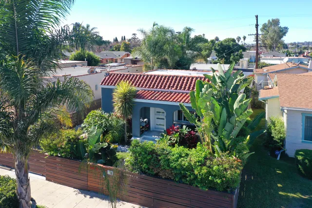 a view of a house with a flower garden
