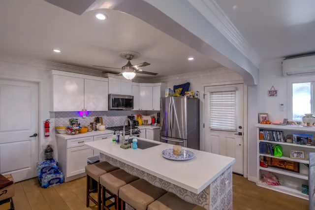 a view of a dining room with furniture and a kitchen