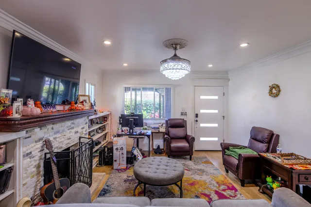 a view of a livingroom with furniture a fireplace and a flat screen tv