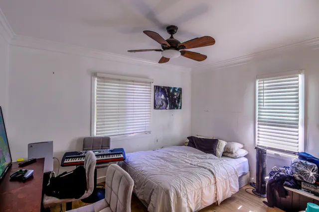 a bedroom with a bed and a window