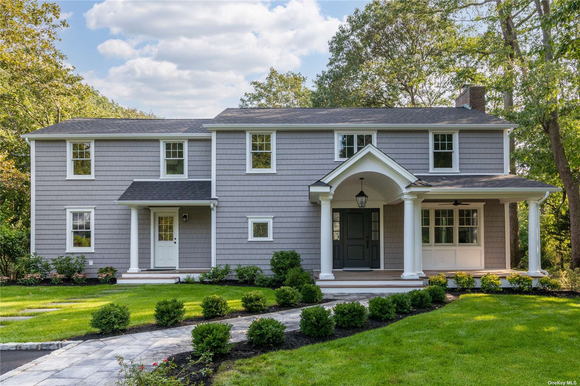 11 Harbor Ridge Drive Centerport, NY 11721 - Photo 1 of 1 a front view of a house with a garden and yard