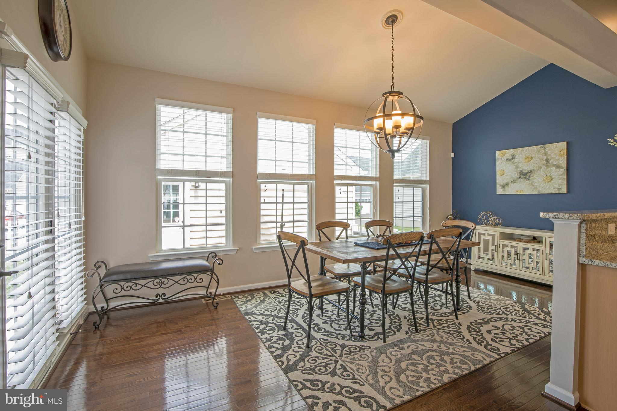 3713 Christopher Day Road Doylestown, PA 18902 - Photo 6 of 20 a dining room with wooden floor a chandelier a wooden table and chairs