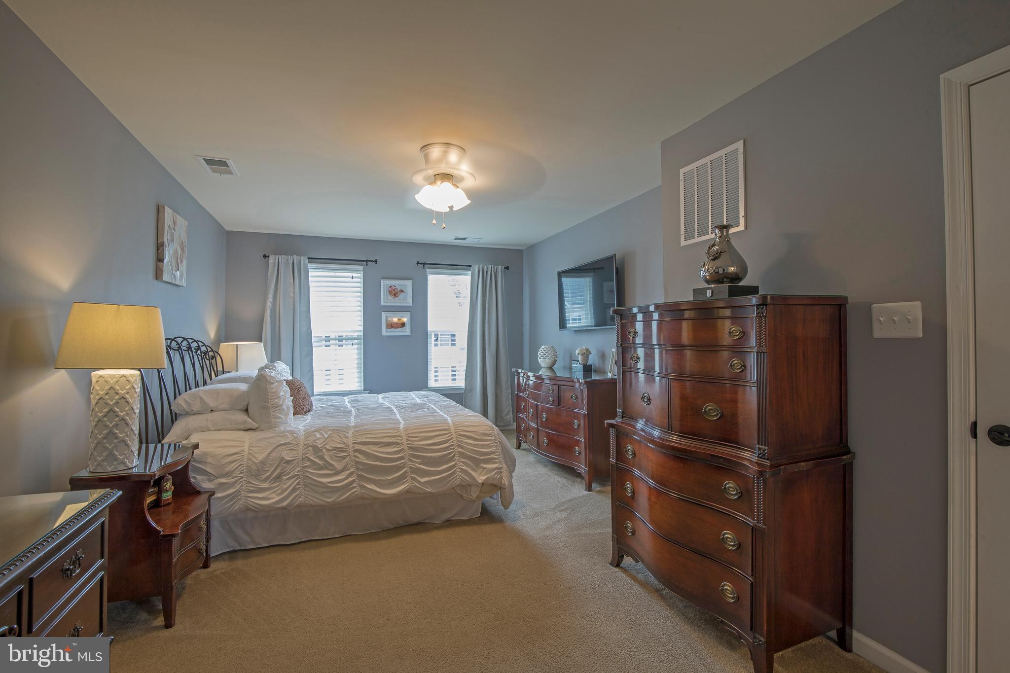 3713 Christopher Day Road Doylestown, PA 18902 - Photo 8 of 20 a bedroom with a bed and wooden floor