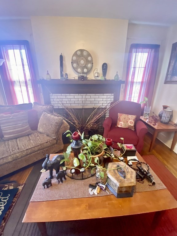 106-108 Maynard Street Springfield, MA 01109 - Photo 2 of 14 a living room with furniture and a fireplace