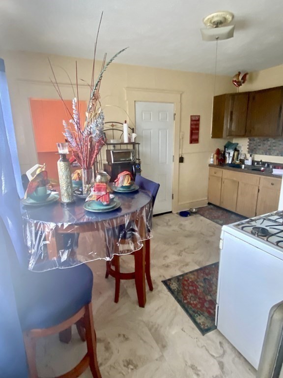 106-108 Maynard Street Springfield, MA 01109 - Photo 5 of 14 a living room with furniture and a dining table