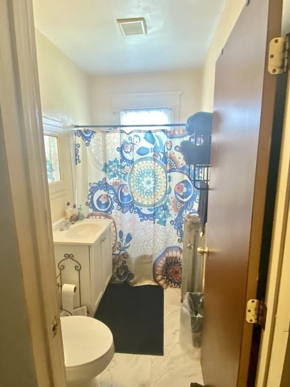106-108 Maynard Street Springfield, MA 01109 - Photo 9 of 14 a bathroom with a sink mirror vanity and toilet