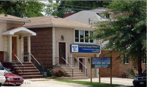 a view of a patio with table and chairs and potted plants