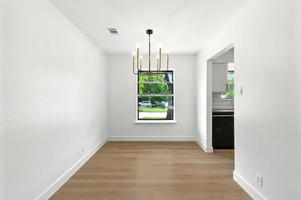 a view of an empty room with windows