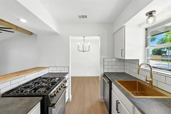 a kitchen that has a sink and a stove