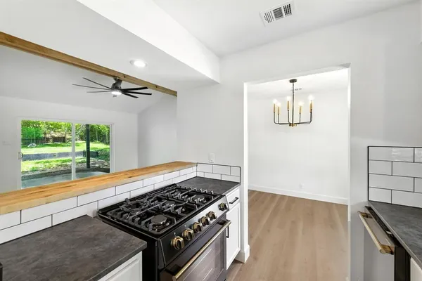a kitchen with a stove and a window